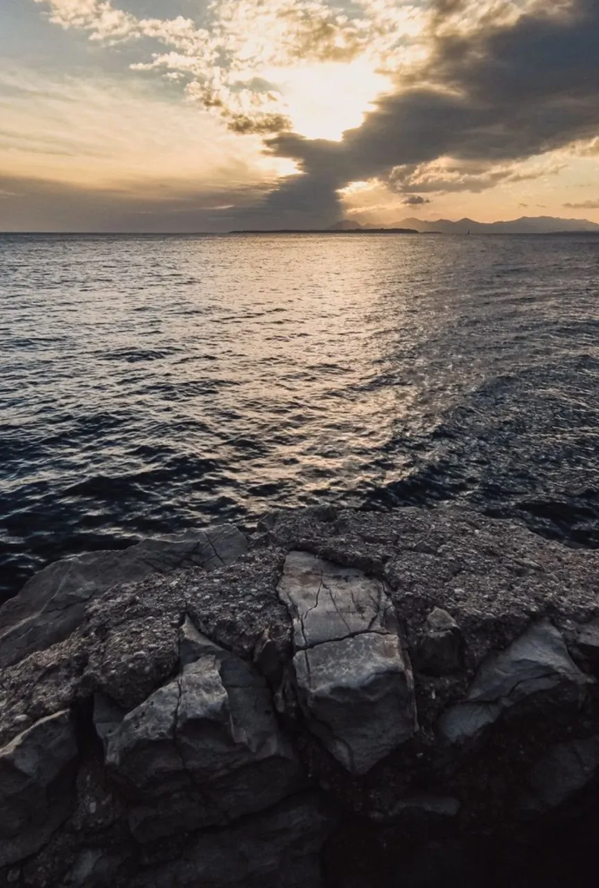 Sunset over rocky shoreline and ocean