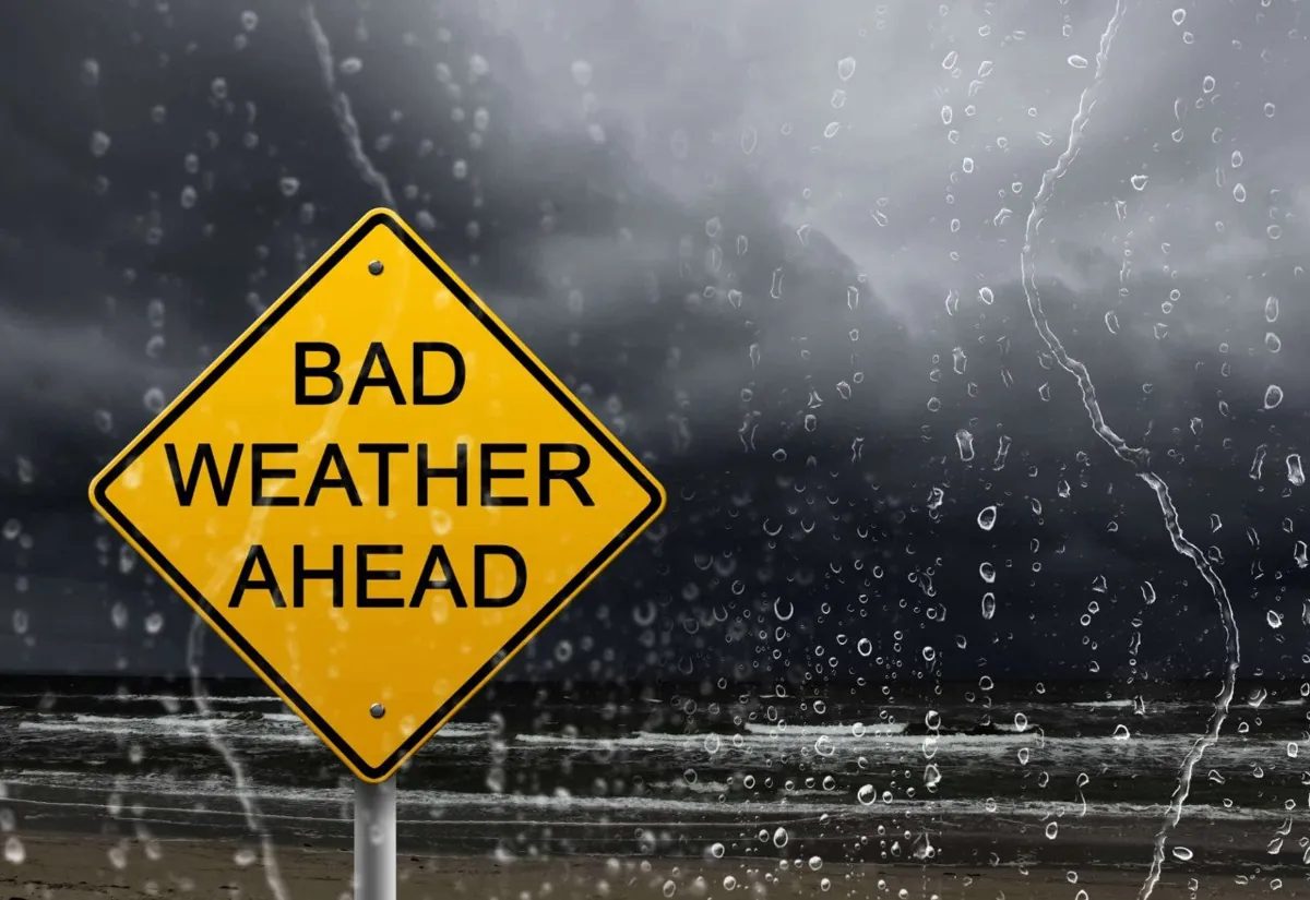 Yellow sign reads 'Bad Weather Ahead'.